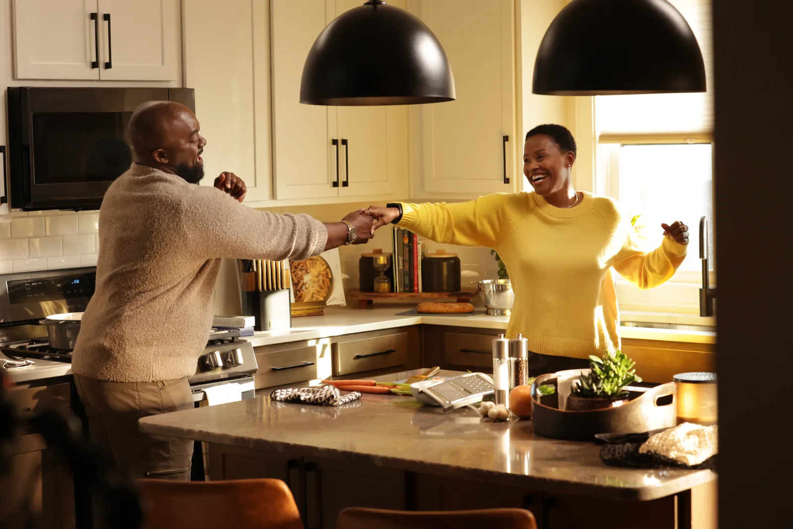 Lifestyle campaign photograph of two people preparing food in a bright kitchen